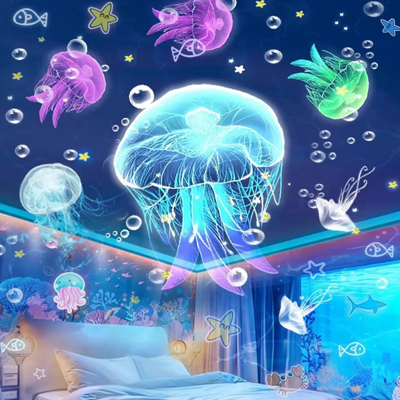 A bedroom decorated with ocean motifs features glowing jellyfish and bubbles above the bed, while Tren-Dora’s StarGlow™ Rotating Galaxy Projector Lamp casts dreamy underwater scenes, creating a whimsical, aquatic atmosphere.